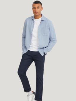 Tenue de voyage homme : look décontracté avec chemise ouverte.