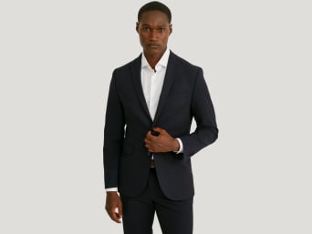 A man wearing a skinny fit suit.
