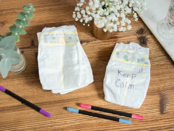 Baby shower game with nappy messages.
