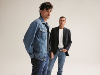 Dva muži mají na sobě moderní pánské džíny. 