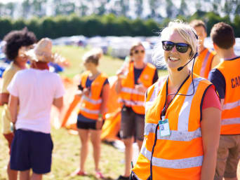 Festival health and safety: festival members of staff wearing high-visibility waistcoats securing an event.