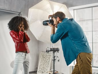 Fashion photography – a model wearing a red leather jacket for a fashion photo shoot.