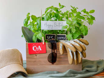 Papa Geschenke: Kräutertöpfe, Gartenhandschuhe, eine Schaufel und eine Mütze sind auf einem Tisch hübsch arrangiert. Papa Geschenke: Kräutertöpfe, Gartenhandschuhe, eine Schaufel und eine Mütze sind auf einem Tisch hübsch arrangiert.