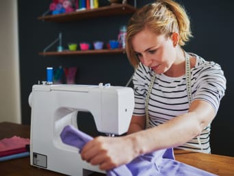 How to sew: a hobby sewer works with her sewing machine.