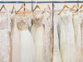 Different types of wedding dresses: wedding dresses hung up in a bridal shop.
