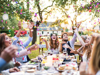 How to plan a wedding: guests celebrating together with the happy couple.
