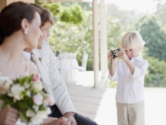 Wedding game ideas:  a boy taking part in a wedding scavenger hunt.