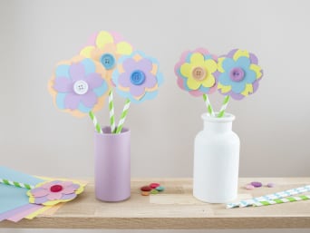 Papierowe kwiaty – gotowe bukiety kwiatowe w wazonach na stole.