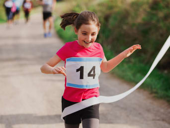 Children's Day activities: a young girl taking part in a charity fun run on World Children's Day.