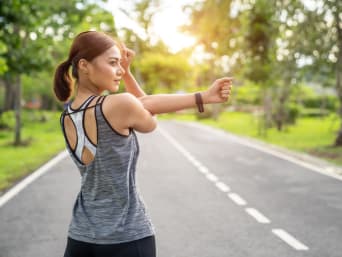 Stretching exercises - woman during cool-down after a run.