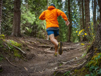 Trail running for beginners: a runner going for a run in a forest.