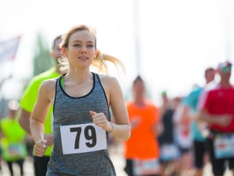Running training goal: Woman taking part in a race.
