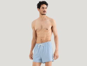 Bathing boxer shorts – a man wearing a pair of bathing boxer shorts that reach the upper part of his legs. Bathing boxer shorts – a man wearing a pair of bathing boxer shorts that reach the upper part of his legs.