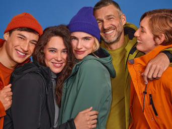 A group of men and women wearing different lightweight jackets.