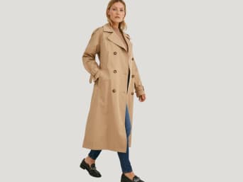 Trench coats are great as transitional jackets: a woman wearing a trench coat.