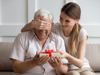 Last-minute gift for Father's Day - adult daughter gives her father a gift.