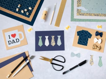 Vyrobte tatínkovi originální dárek ke Dni otců: Na stole leží materiály a potřeby pro výrobu DIY přání ke Dni otců.