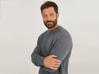 A man wearing a cashmere jumper.