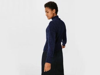 Chenille - a woman wearing a blue chenille jumper.