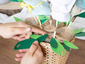 Attach leaves to decorate the last-minute baby gift.