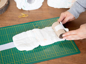 Make your own nappy cake - making wheels from nappies.
