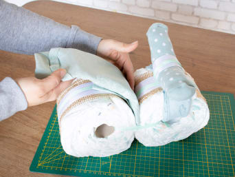 Making a motorbike nappy cake - mudguard made from a bodysuit.