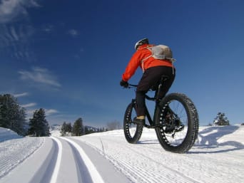 Nuevas tendencias en deportes de nieve: un hombre hace una ruta con fat bike por la nieve.
