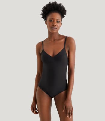 Shapewear for your bust: a woman wearing a padded shapewear bodysuit.