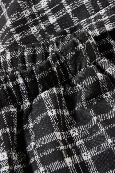 Exclusiv online - CLOCKHOUSE - pantaloni de stofă - talie medie - palazzo - în carouri - negru / alb