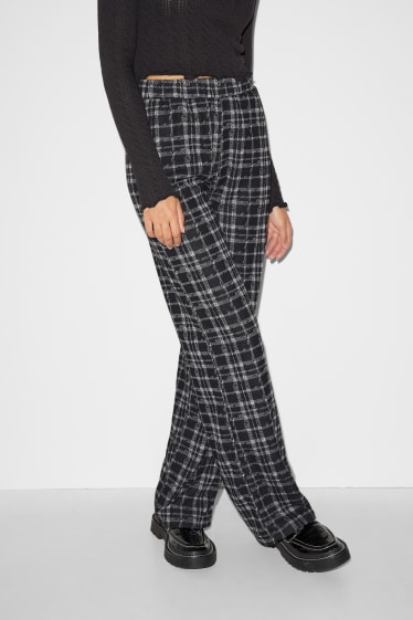 Exclusiv online - CLOCKHOUSE - pantaloni de stofă - talie medie - palazzo - în carouri - negru / alb