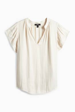 Brusa amb el coll en punta