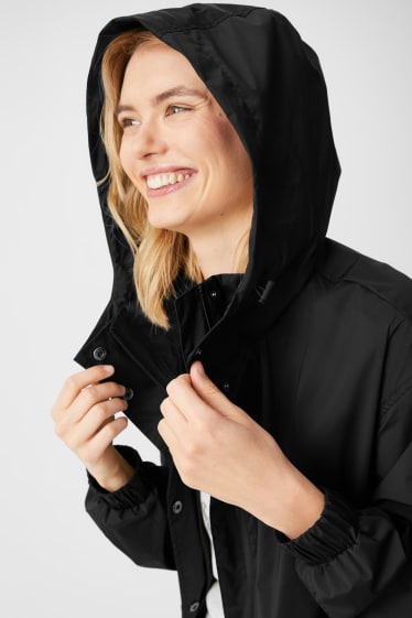 Damen - Regenmantel mit Kapuze - faltbar - schwarz