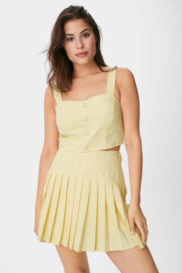 Women - Mini skort with pleats - light yellow