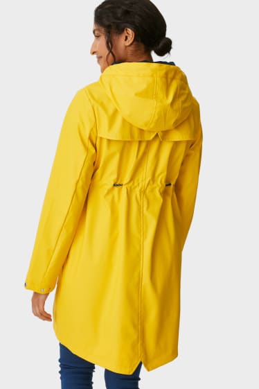 Damen - Umstands-Regenjacke mit Kapuze und Baby-Einsatz - gefüttert - gelb