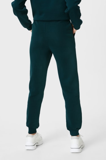 Mujer - CLOCKHOUSE - pantalón de deporte - Peanuts - verde oscuro