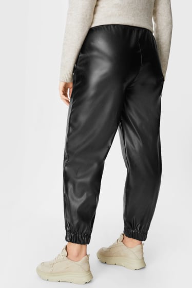 Dámské - Teplákové kalhoty - imitace kůže - černá