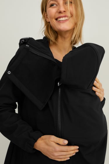 Kobiety - Ciążowa kurtka softshell z kapturem i wstawką dla niemowląt - czarny