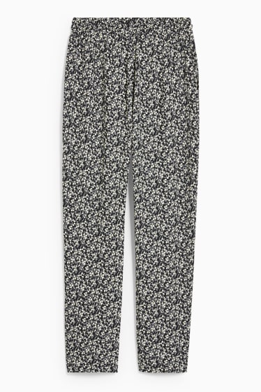 Jóvenes - CLOCKHOUSE - pantalón de tela - tapered fit - de flores - negro