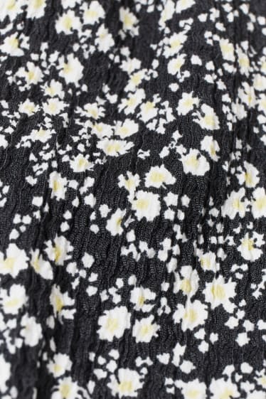 Adolescenți și tineri - CLOCKHOUSE - pantaloni de stofă - tapered fit - cu flori - negru