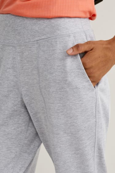 Dámské - Funkční teplákové kalhoty - fitness - 4 Way Stretch - světle šedá-žíhaná