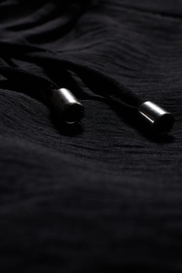 Femmes - Pantalon en toile - mid waist - jambe évasée - noir