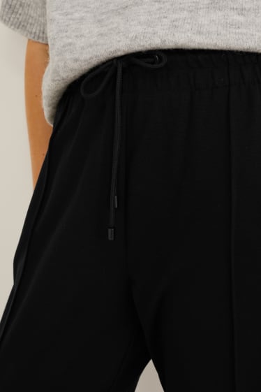 Kobiety - Spodnie z dżerseju - tapered fit - czarny