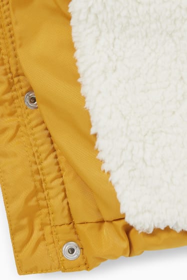 Niemowlęta - Pikowana kurtka niemowlęca z kapturem i obszyciem z futerka  - żółty