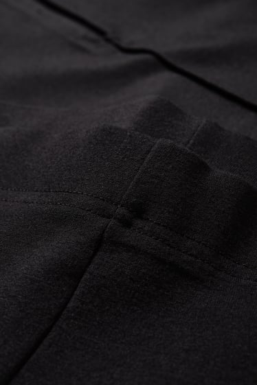 Ragazzi e giovani - CLOCKHOUSE - pantaloni di jersey - taglio flared - nero