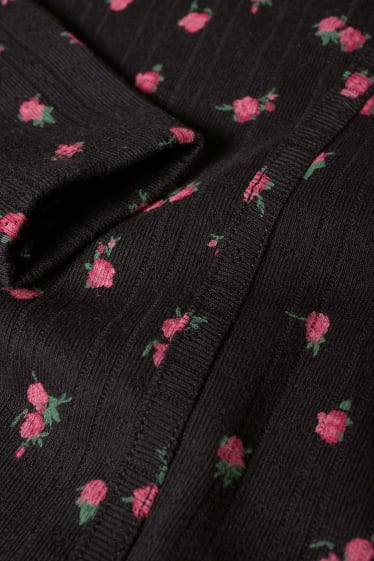Nastolatki - CLOCKHOUSE - krótka bluzka z długim rękawem - w kwiatki - czarny