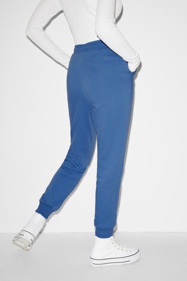 Nastolatki - CLOCKHOUSE - spodnie dresowe - Snoopy - niebieski