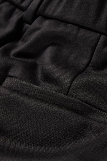 Dámské - Žerzejové kalhoty - tapered fit - černá