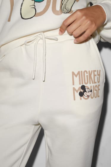 Dámské - CLOCKHOUSE - teplákové kalhoty - Mickey Mouse - krémově bílá