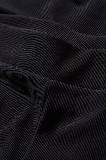 Kobiety - CLOCKHOUSE - dżersejowe spodnie - flared - czarny