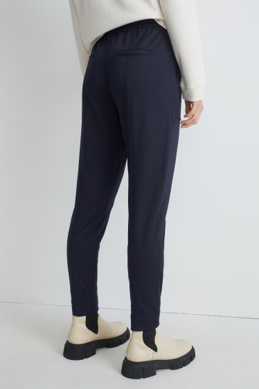 Dona - Pantalons de tela - mid waist - tapered fit - blau fosc